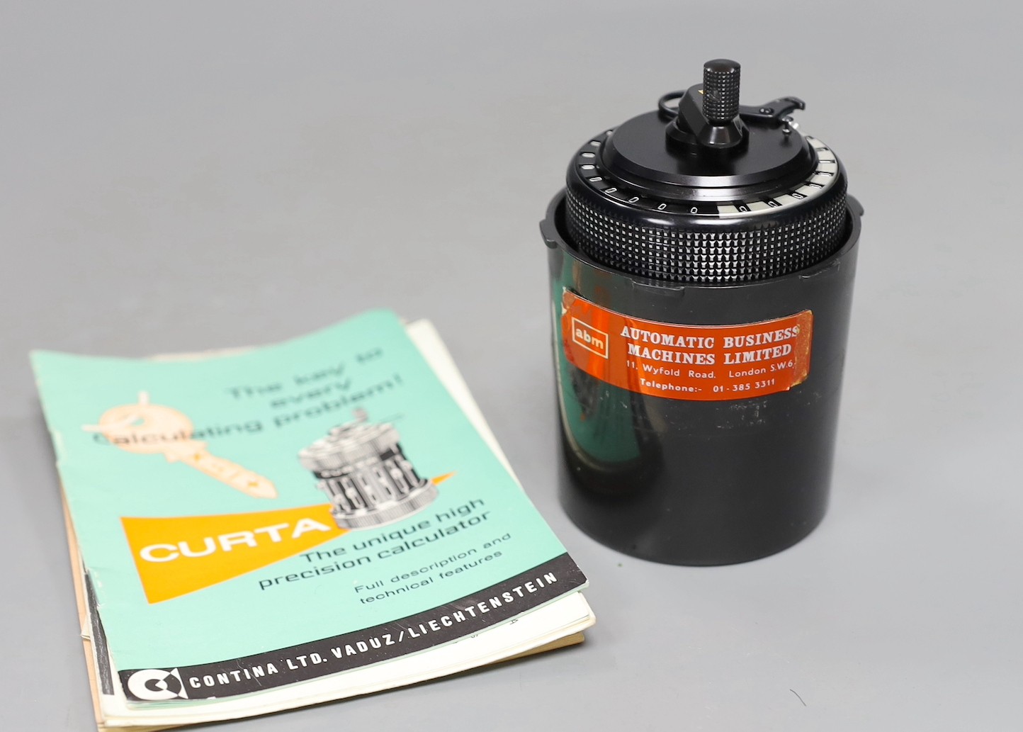 A Curta patent calculator serial number 535523, cased with original paperwork, case 12cms high